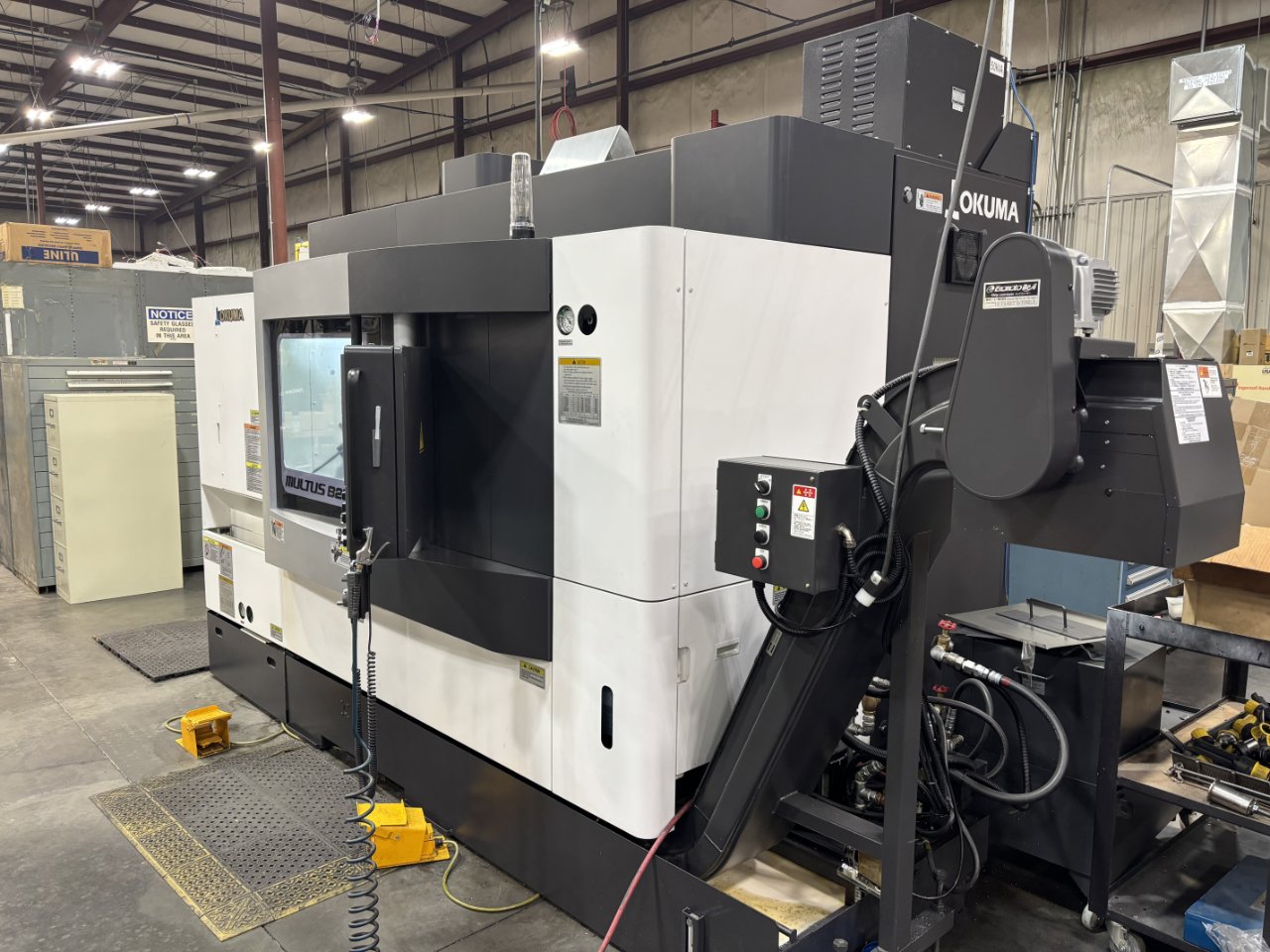2022 Okuma MULTUS B250II wide front view with chip conveyor and yellow foot pedals