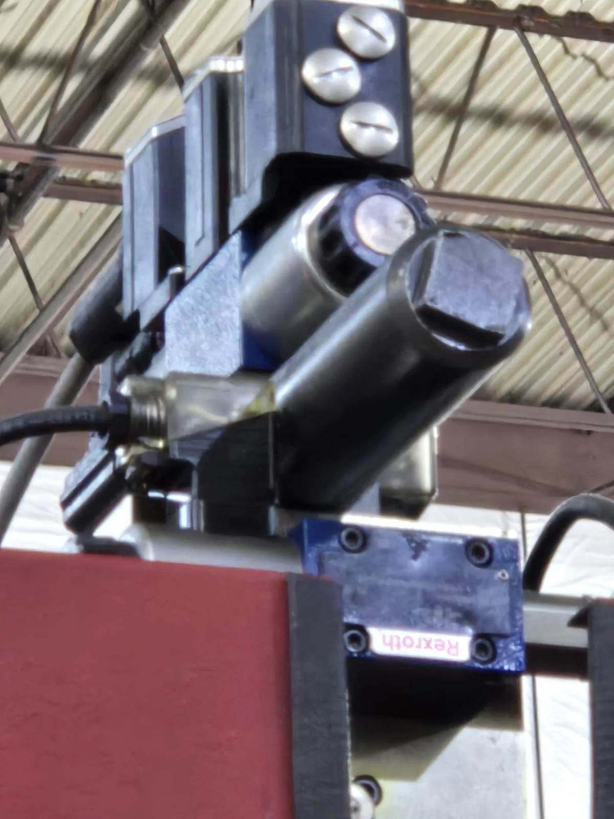 Rexroth hydraulic valves on top of Accurpress Accell press brake red frame