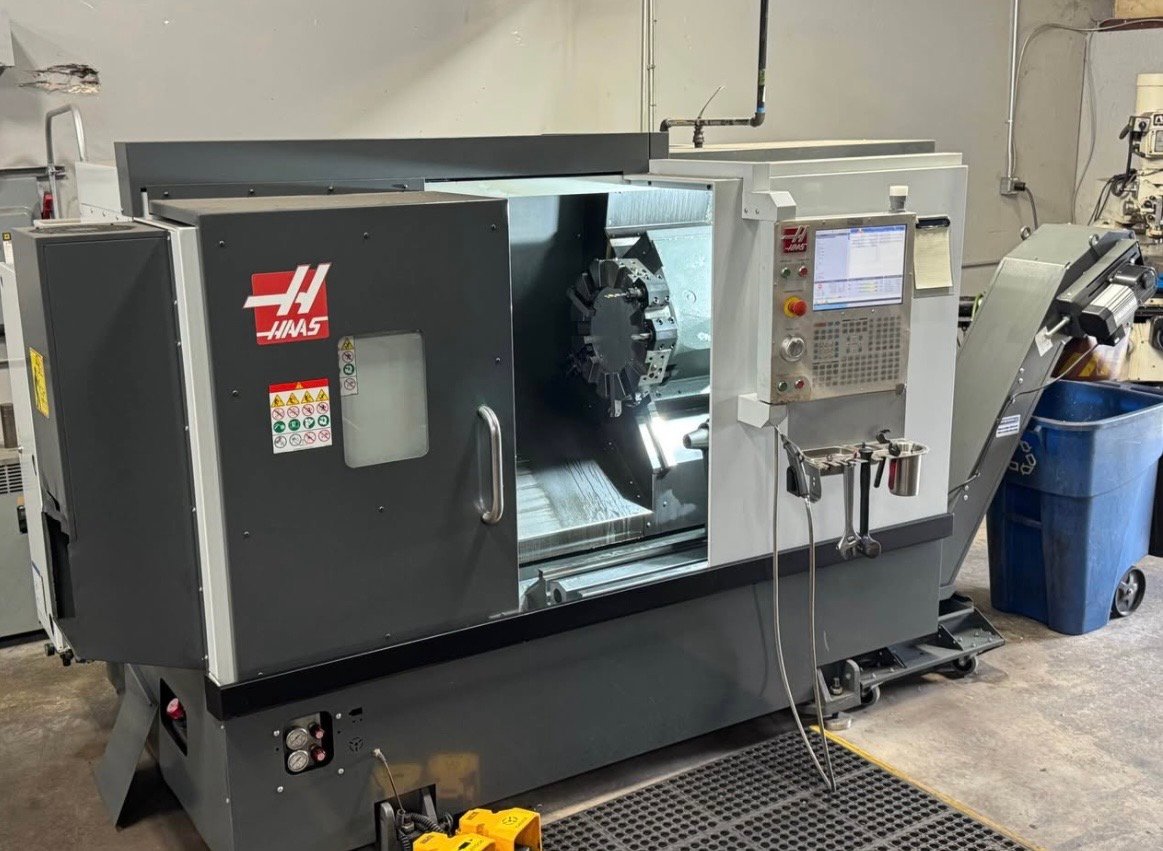 Close three-quarter view of Haas ST-25 with open work envelope, turret, and Haas control pendant